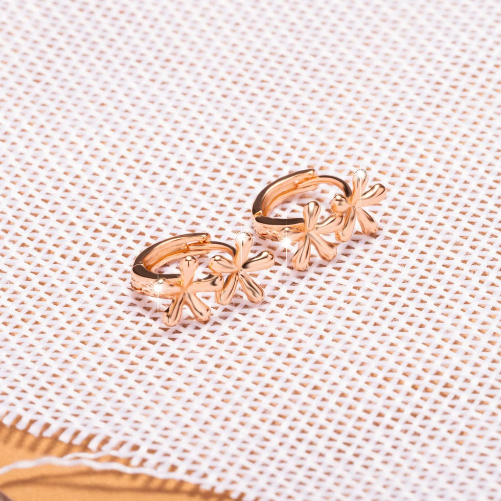 Circular rose gold earrings with a waterdrop flower pattern, shown front-on.