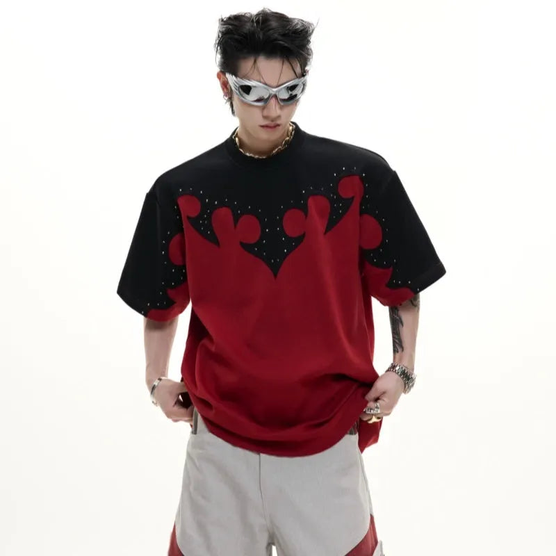 Grey men's T-shirt with raised black floral embroidery and rhinestone details on a dropped shoulder, loose-fit design.