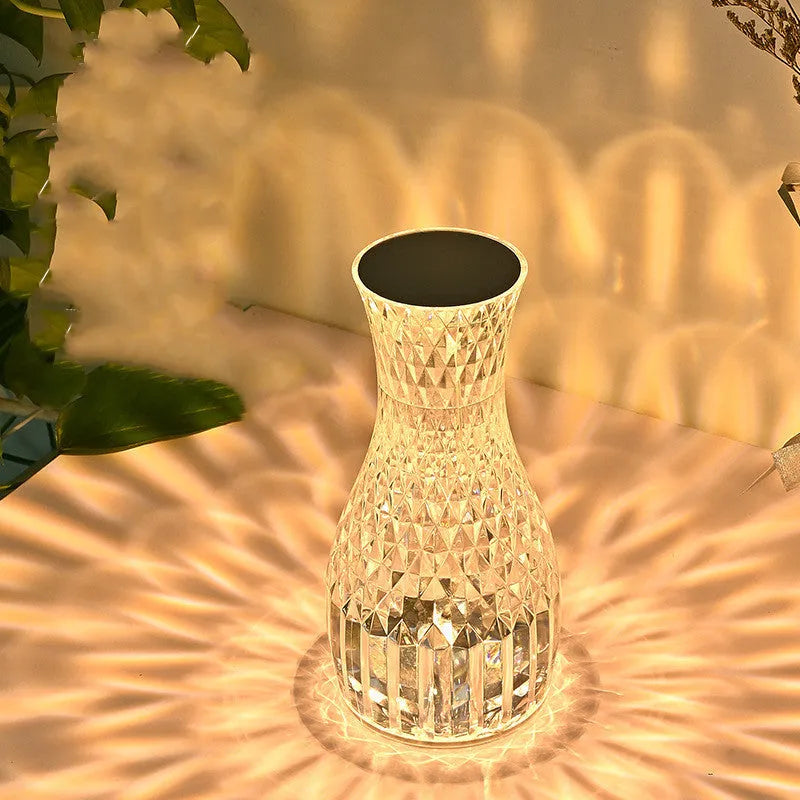 Vase-shaped crystal table lamp with diamond-like LED lighting on wooden surface