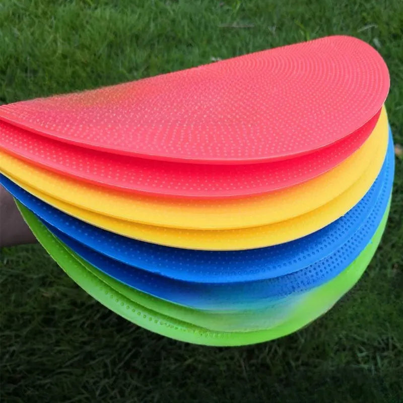 Yellow football training marker disc on grass field showing 23cm diameter flat design