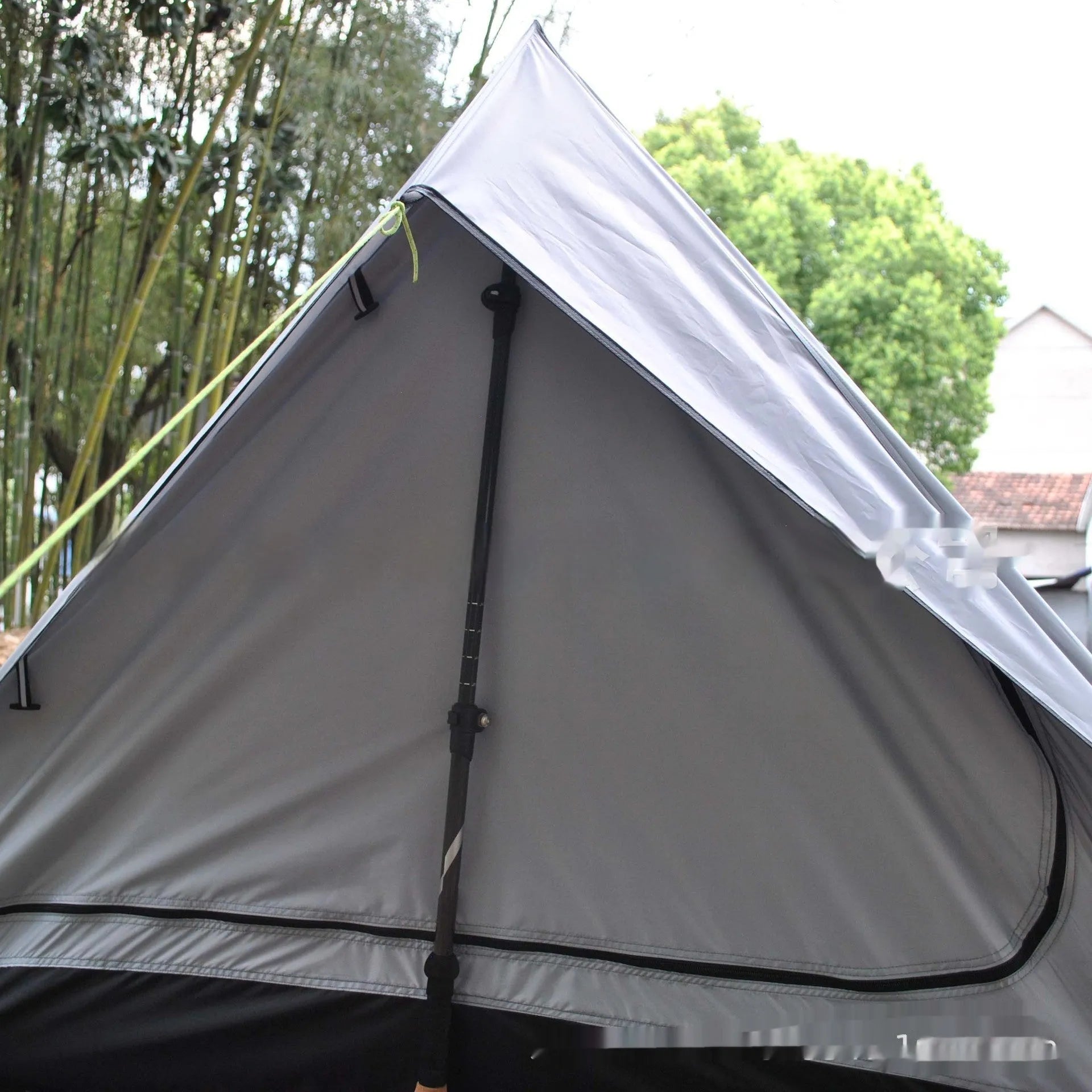 Brown and white pole-free A-line cabin tent for 2-3 people shown pitched with hiking poles.