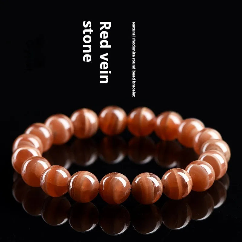 Natural Old Mine Rhodochrosite round bead bracelet with Ruyi element, shown in 6mm and 8mm sizes.