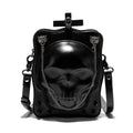 Black mini square crossbody bag with embossed skull design, metal chain strap, and zip opening.