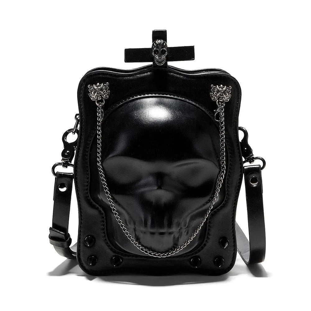 Black mini square crossbody bag with embossed skull design, metal chain strap, and zip opening.