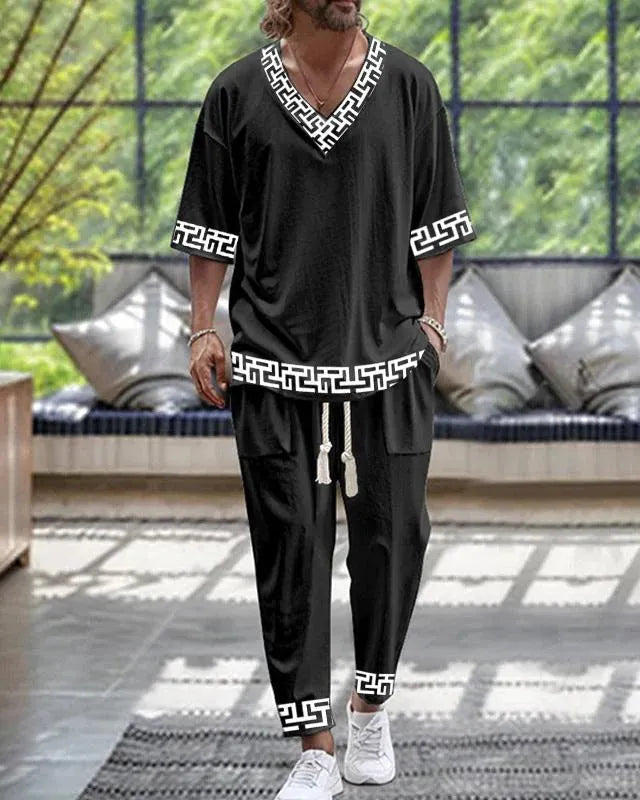 Cropped sleeve V-neck jacket and trousers suit in thin polyester fabric on a hanger.