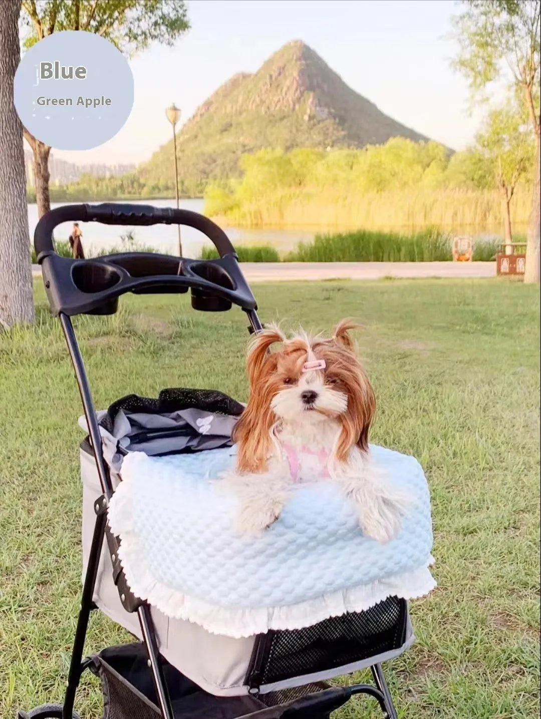 A green grey striped towel, cushion, and pillow set for a pet stroller, shown removed and ready for washing.