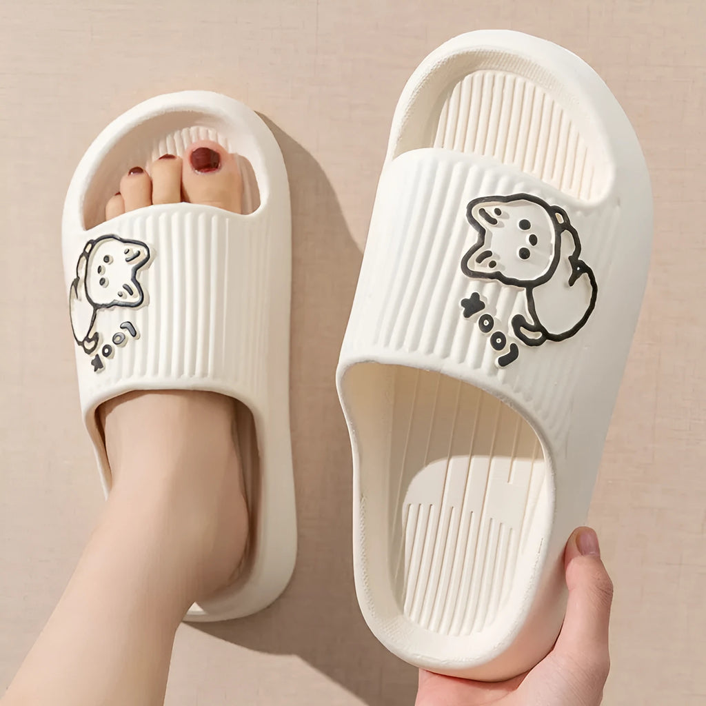 Women's pink EVA cat slippers with thick platform sole on a wooden floor.