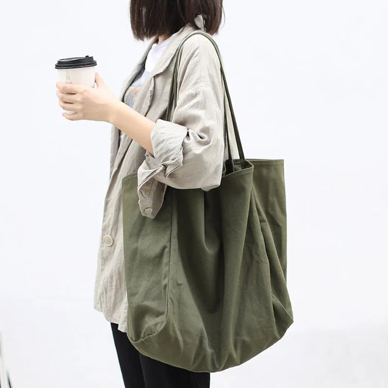 Large canvas shoulder tote bag in solid colour with soft handle, open top, and internal phone pocket