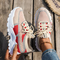 Women's Flyknit mesh lace-up sneakers in grey and white with a low rubber sole.