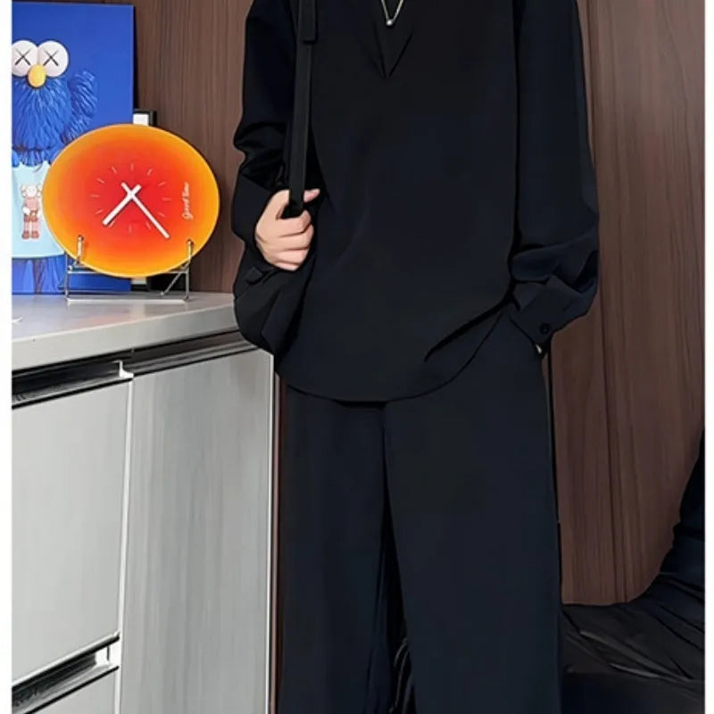 Men's black casual two-piece set with long sleeve polo shirt and trousers on a hanger