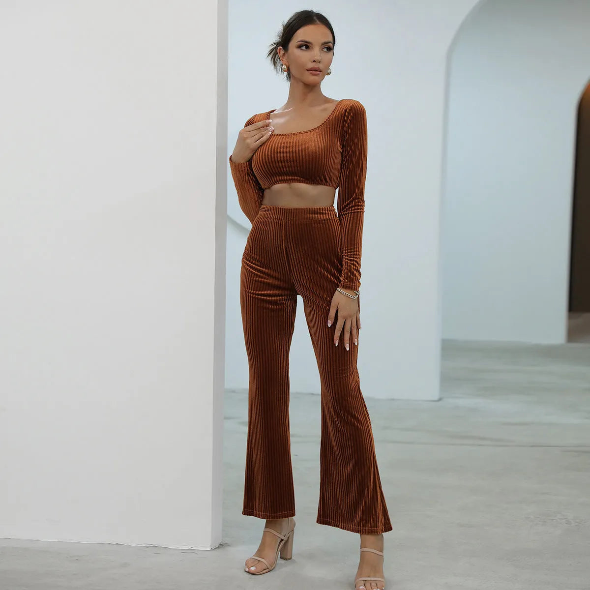 Caramel coloured long sleeve sweater and straight-leg trousers set on a hanger