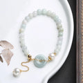 Natural emerald green jade bracelet with pearl accents and peace symbol buckle clasp