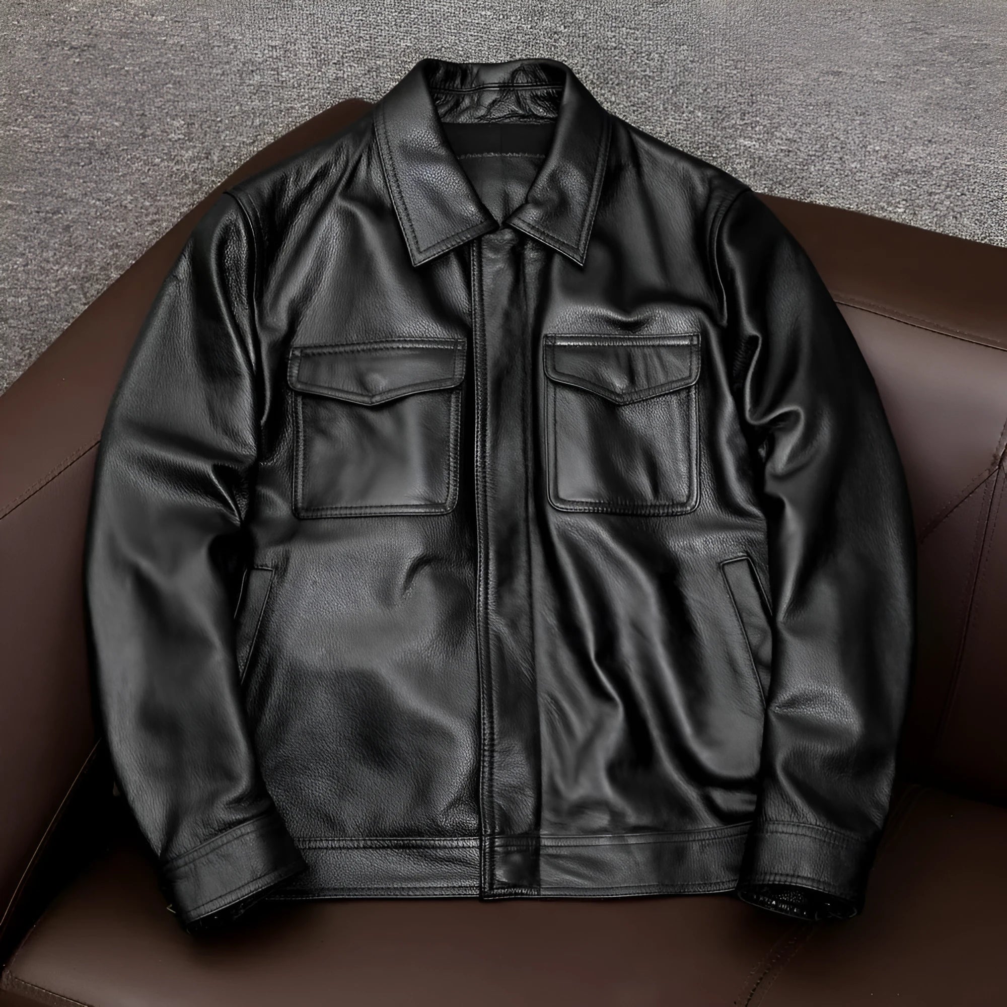 A man's black plus size PU leather jacket with a lapel and side pockets, shown on a hanger.