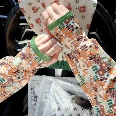 A pair of lightweight ice silk sun protection sleeve gloves in a floral print pattern, covering from wrist to elbow.