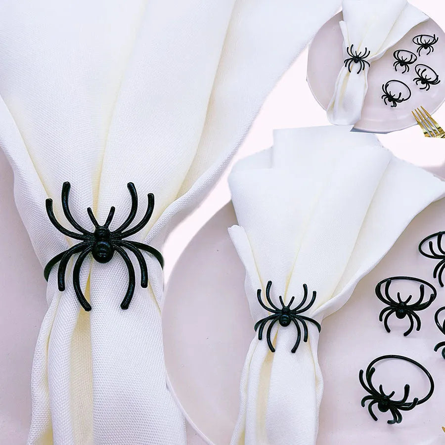 Set of six black alloy napkin rings with detailed spider sculpture for Halloween table decor.