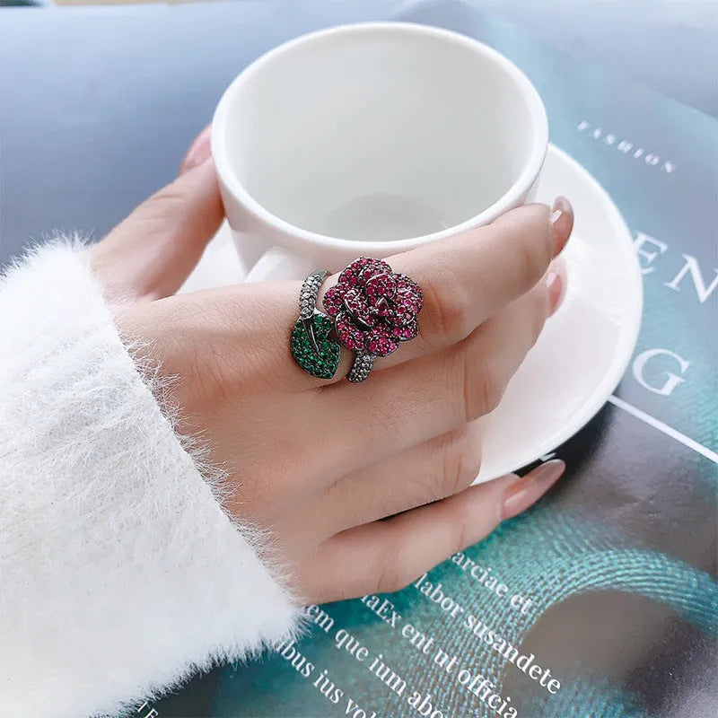 Geometric black gold plated flower ring with red simulated corundum stones for women.
