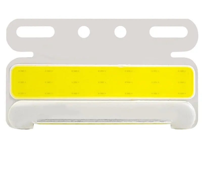 Aluminium alloy COB LED truck side light projecting bright white light onto ground next to tyre.