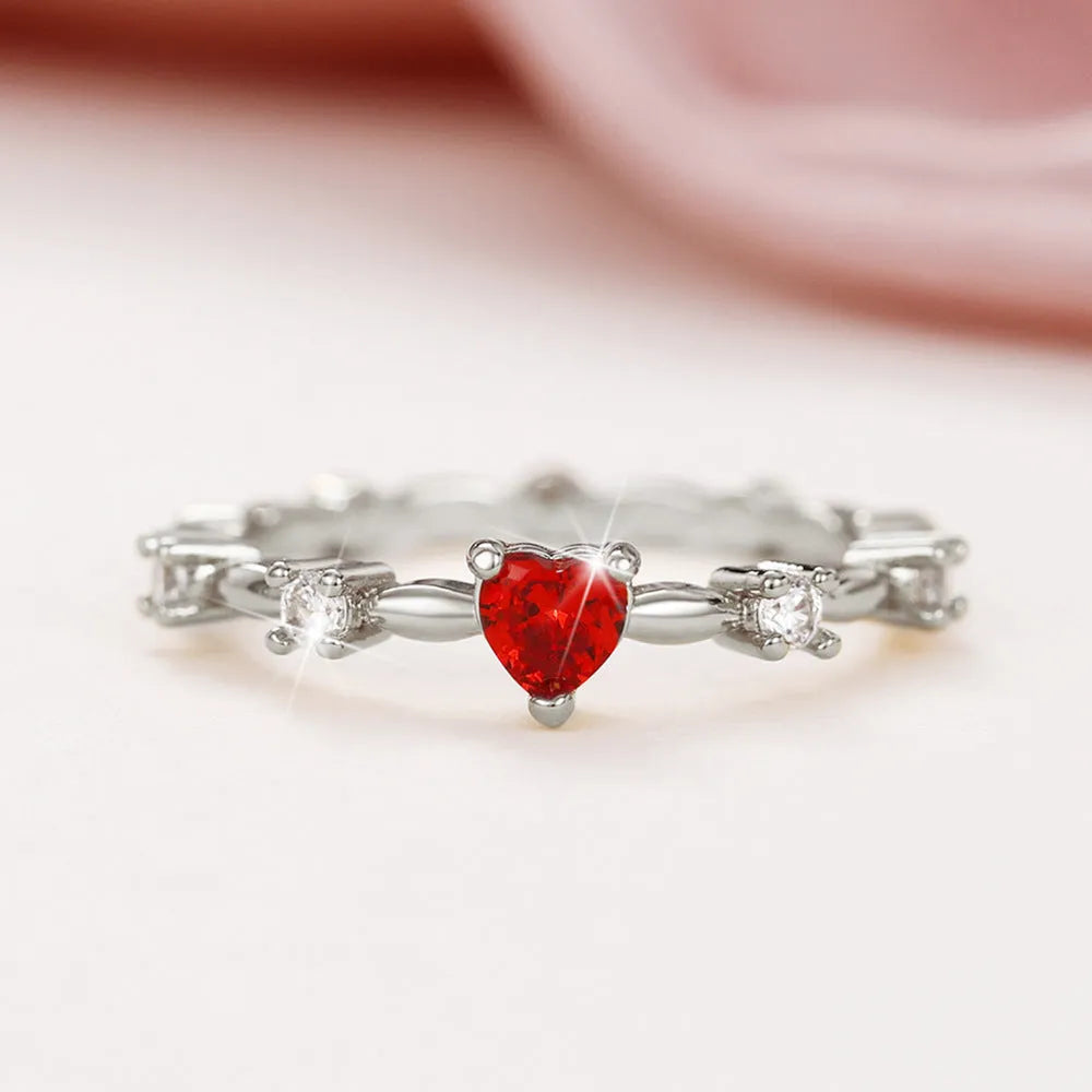 Personalised gold or silver plated ring with a peach heart charm and clear zircon stones.