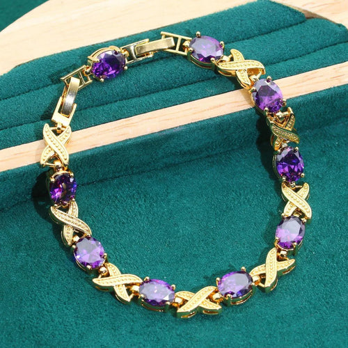 18k gold plated zircon jewellery set with necklace, earrings, ring, and bracelet on blue background