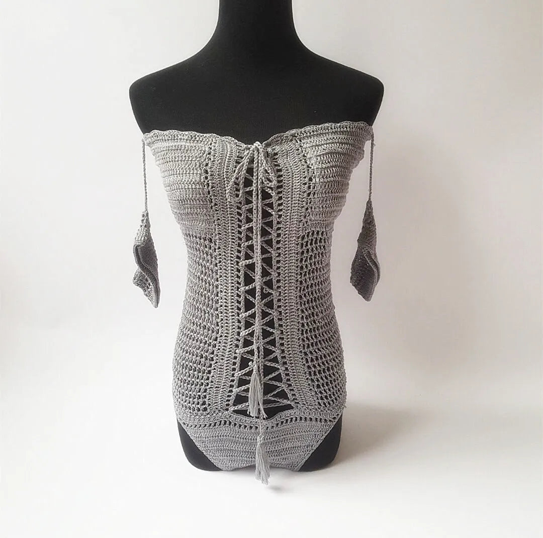 Off-shoulder one-piece swimsuit in polyester fabric on a mannequin.