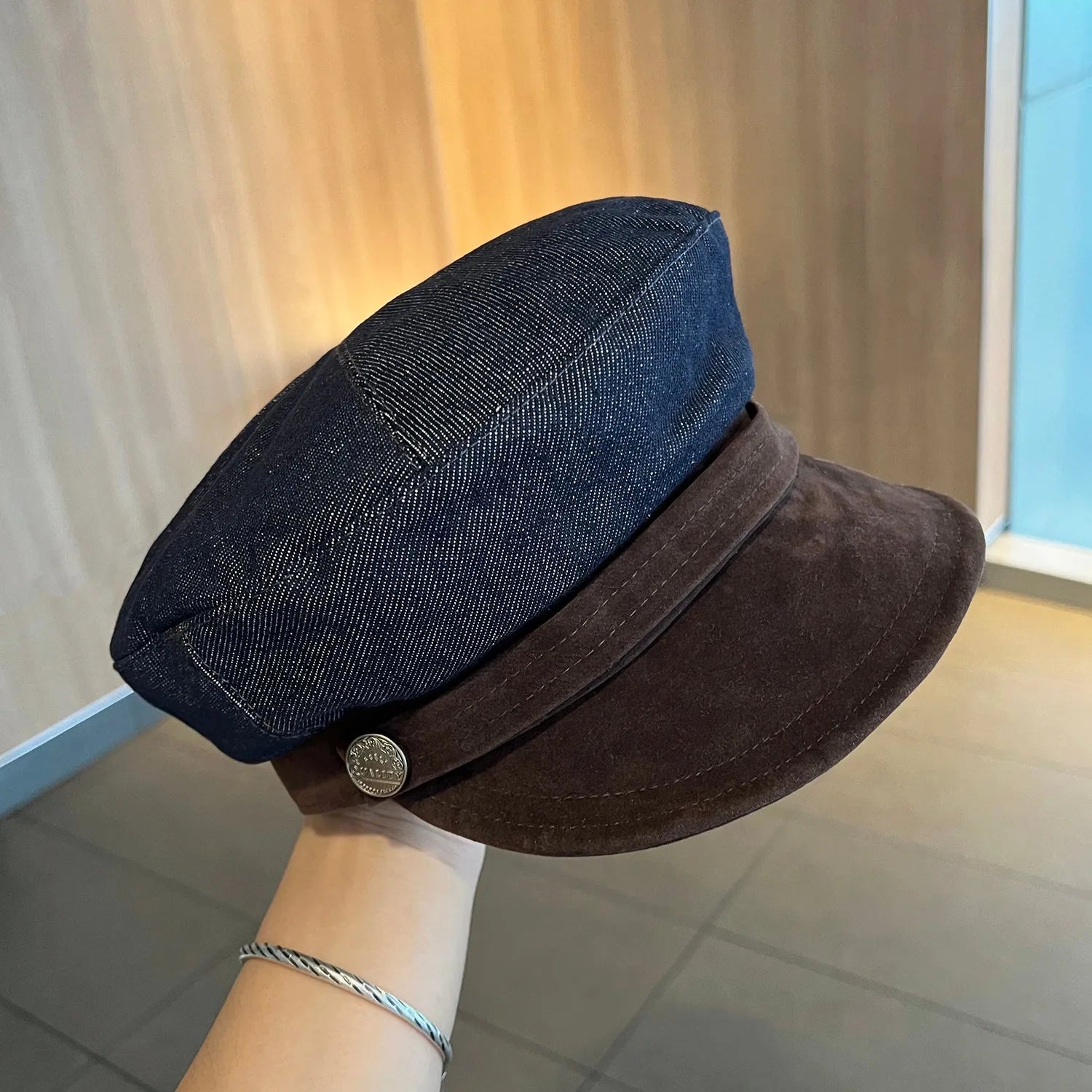 Dark blue denim newsboy hat with octagonal retro design and adjustable sizing