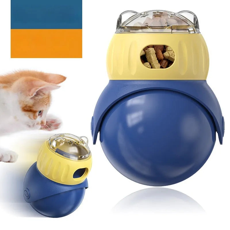 Owl-shaped yellow and blue plastic puzzle feeder for cats on a wooden floor.