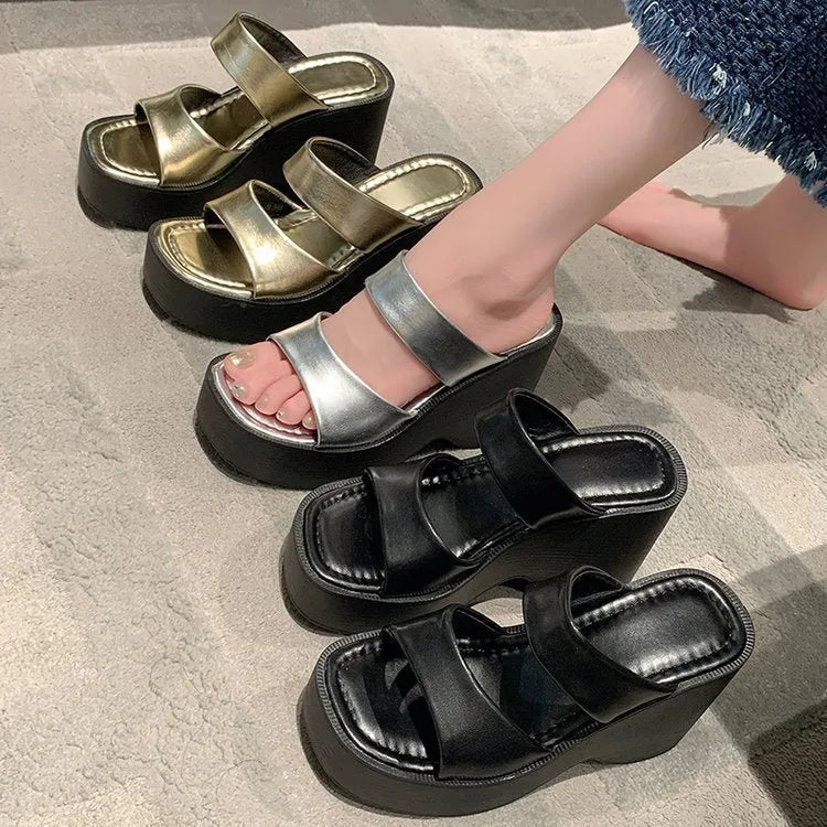Women's black wedge platform slippers with a square toe and PU upper material.