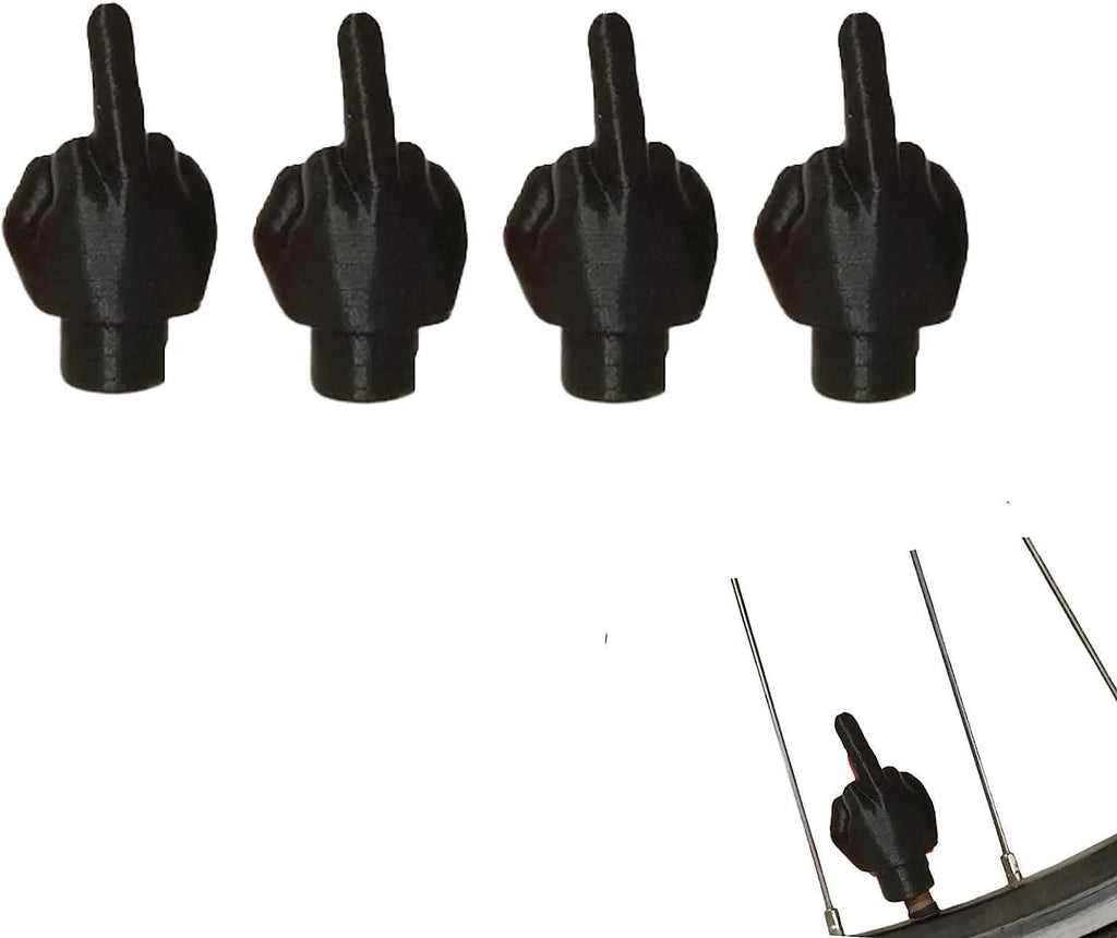Four latex tyre valve caps showing two skin colour and two black pieces for car tyre protection