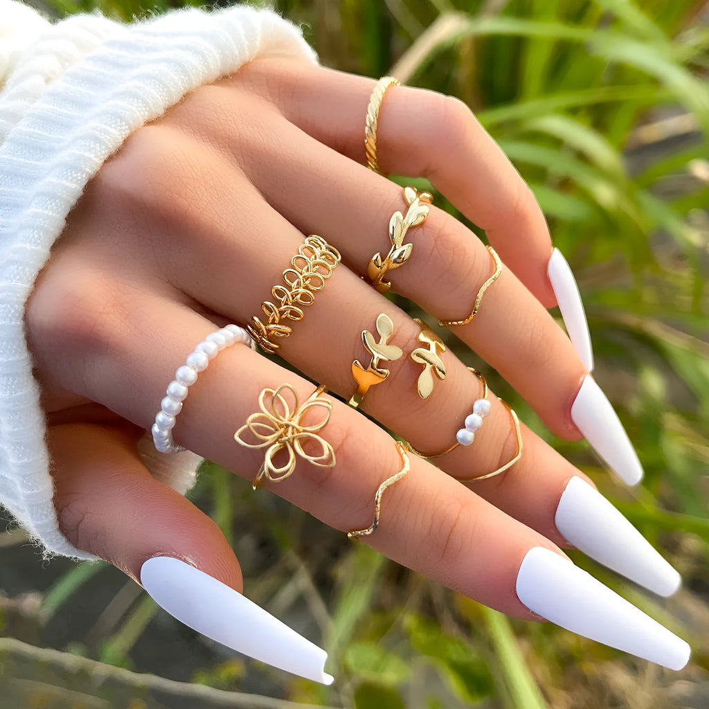 Gold colour openwork flower ring with detailed floral design and glossy electroplated finish