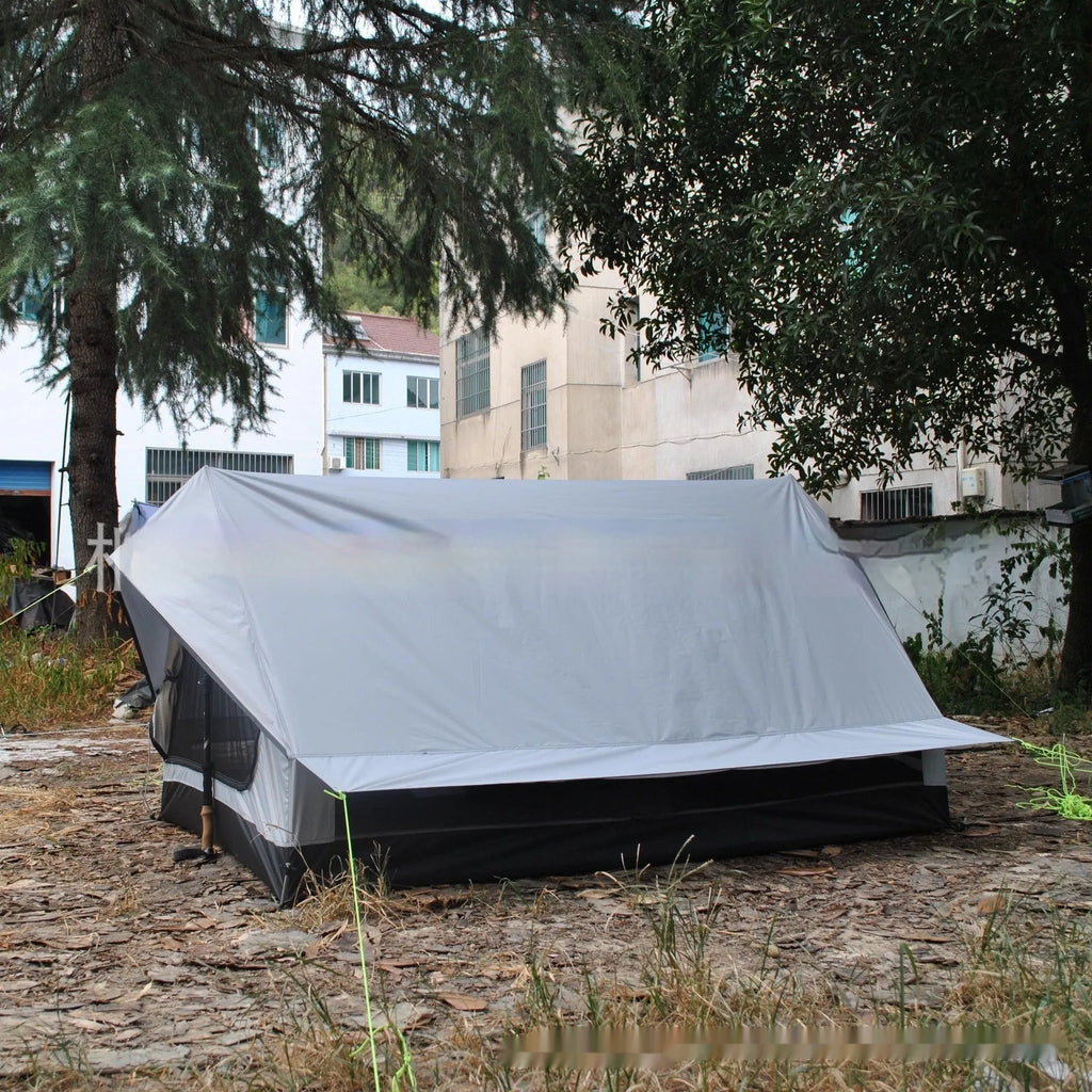Brown and white pole-free A-line cabin tent for 2-3 people shown pitched with hiking poles.