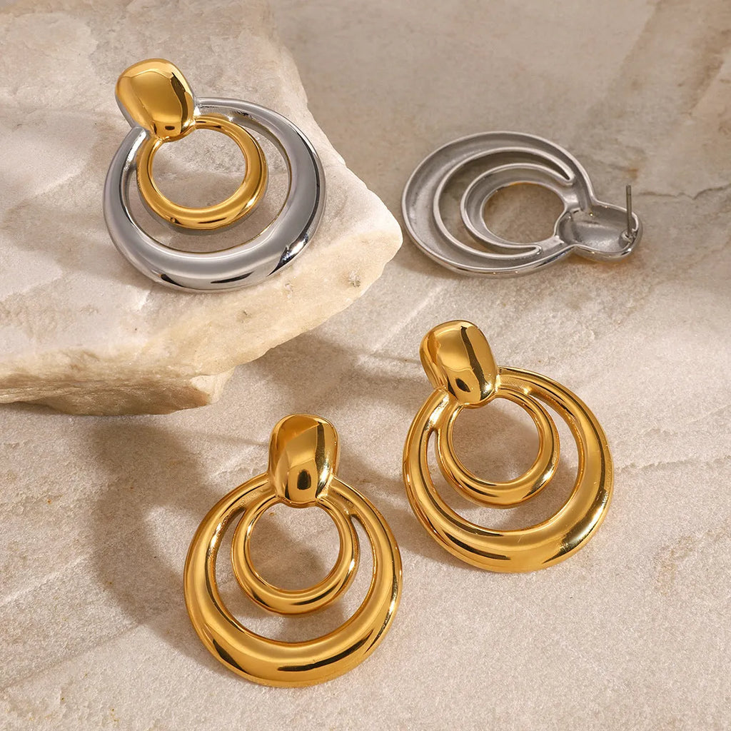 Golden titanium steel stud earrings with double-layer hollow design and round geometry shape