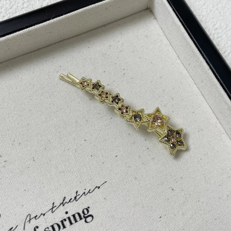 Gold electroplated alloy hair barrette with side clip and five-pointed star charm decoration