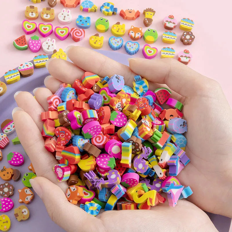 Sealed plastic bag containing 50 small cartoon-themed erasers in shapes like fruits, animals, and Christmas symbols.
