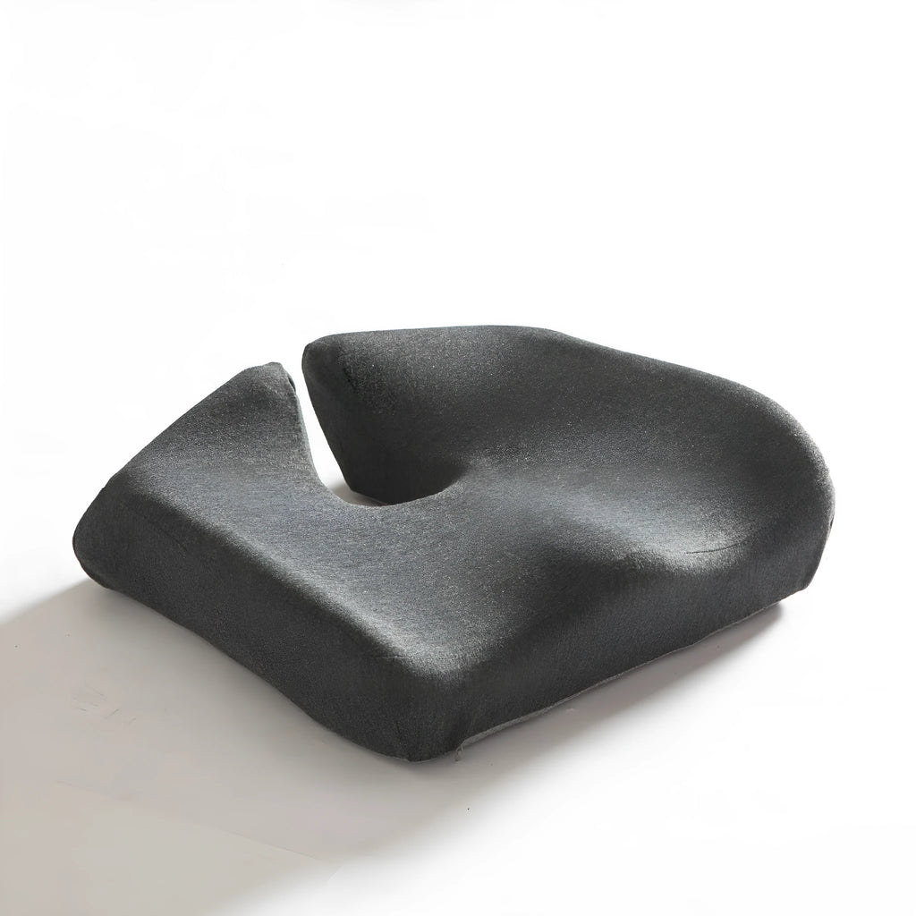 Dark grey memory foam office chair cushion for lumbar support on a desk chair.