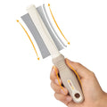 White double-sided dog and cat grooming brush with curved comb and deshedding bristles