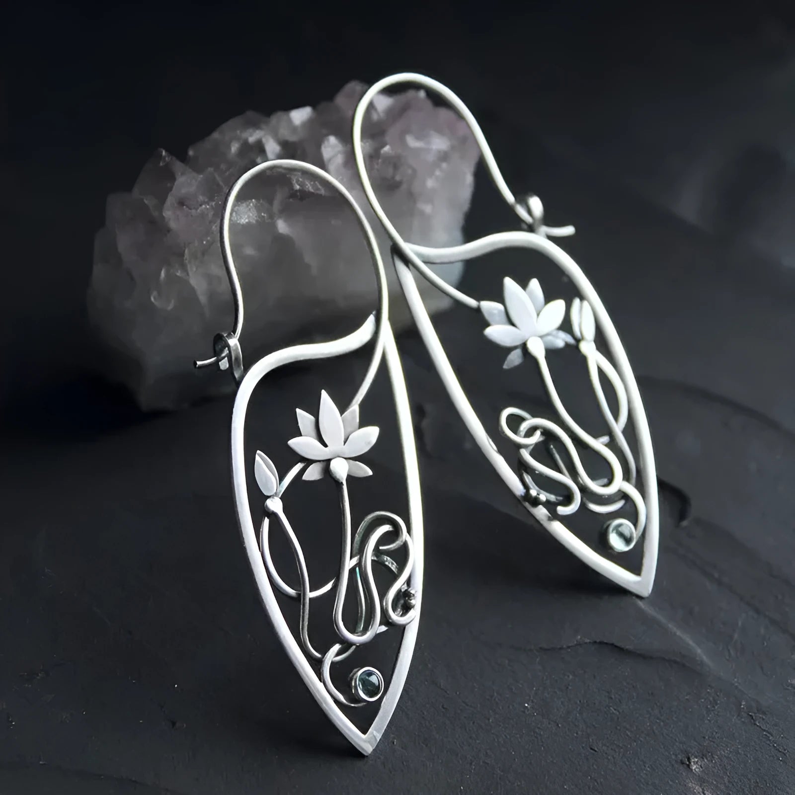 Silver geometric lotus vine earrings with rhinestone accents on white background