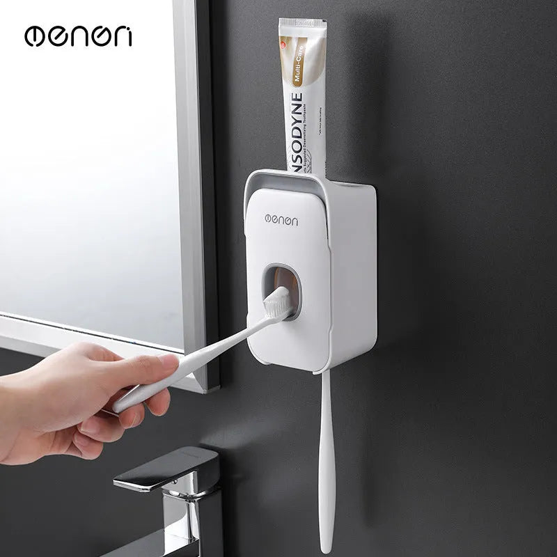 Blue automatic toothpaste dispenser made of ABS plastic mounted on a bathroom wall.