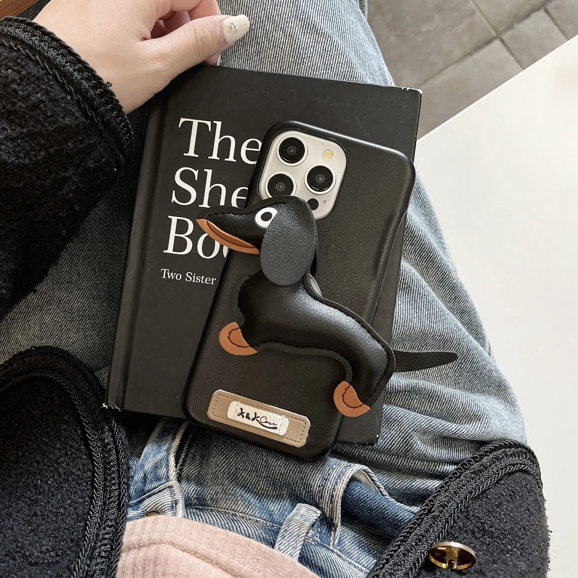 Sausage dog bracket phone case with imitation leather finish in black shell, compatible with iPhone models