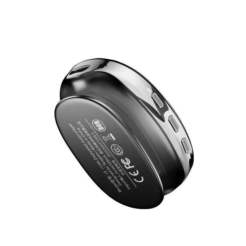 A compact black Bluetooth MP4 music player with an OLED screen showing the menu.