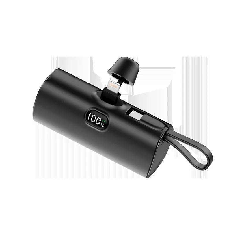 Capsule shaped digital display wireless power bank in multiple colours showing its compact size and built-in plug.