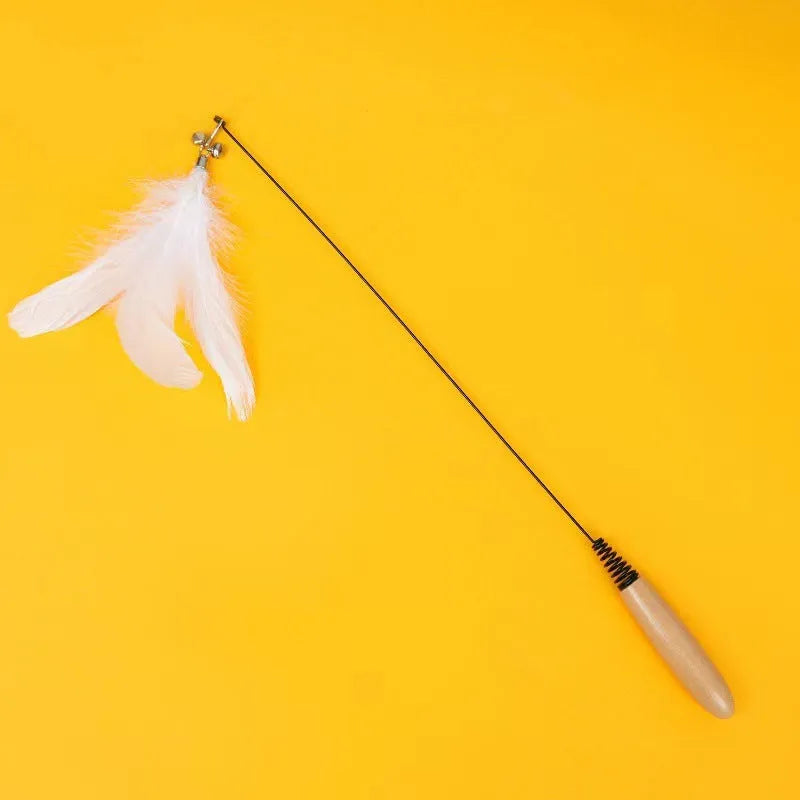 Close-up of a feather and bell replacement head for a spring cat teasing stick toy.