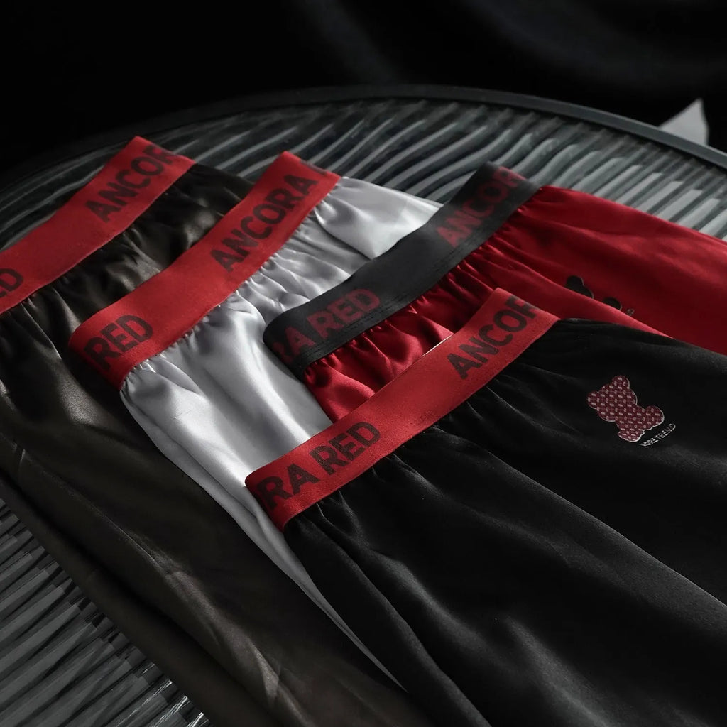 Men's solid colour boxer briefs in black, shown with mid-waist design.