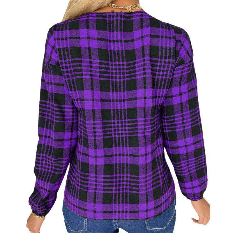 Women's loose fit purple plaid casual shirt with regular sleeves on a hanger.