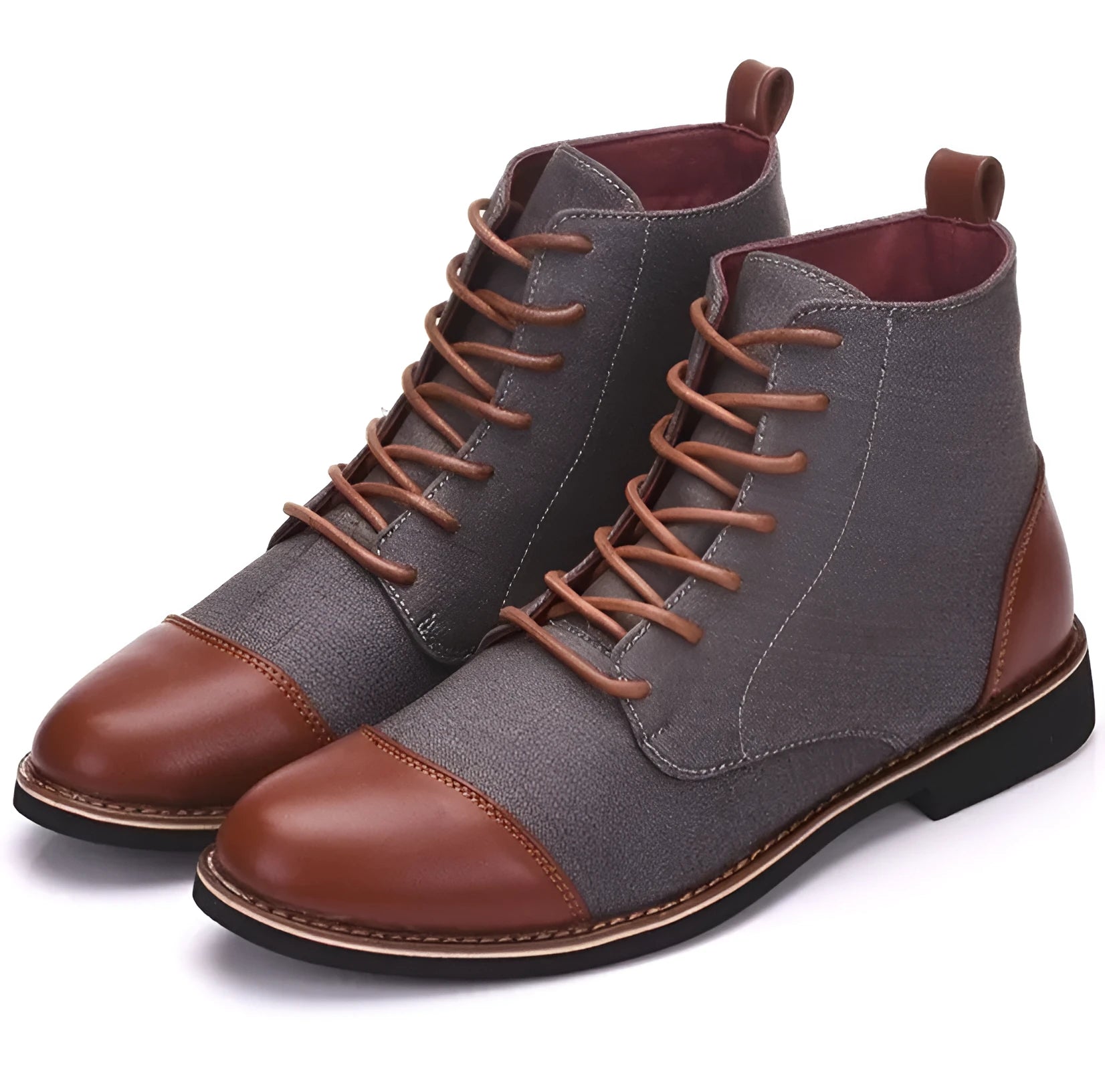Men's black leather motorcycle ankle boots with side belt buckles and a thick rubber sole on a wooden floor.