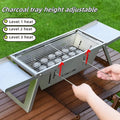 Small portable charcoal grill shown in a folded position for easy transport.