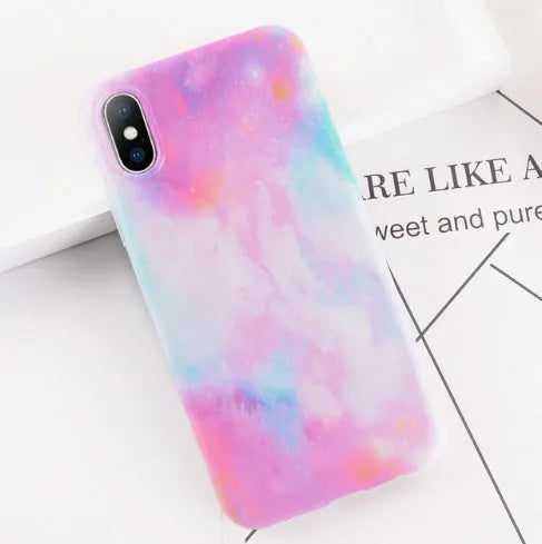 Colourful stone pattern soft protective case for iPhone X, 8, 7, 6, and 6s Plus models on a table.