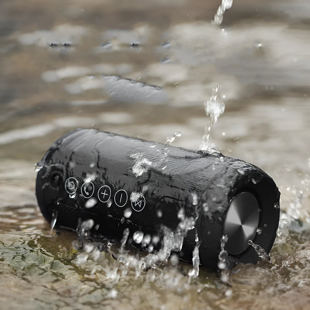 Outdoor portable Bluetooth speaker in camouflage colour with buttons for volume, playback, and mode selection.