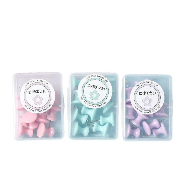 Plastic push pins in cherry blossom pink, mint green, and lavender colours, showing both large and small sizes on a white surface