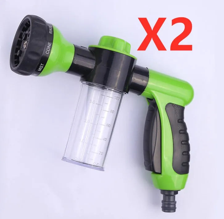 Green high-pressure foam spray gun for car washing with adjustable nozzle and attached water pipe.
