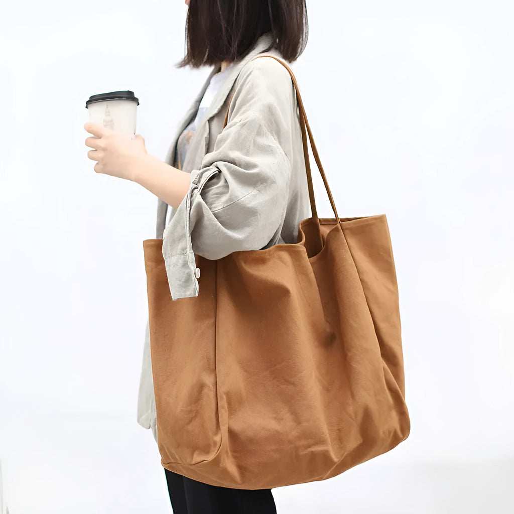 Large canvas shoulder tote bag in solid colour with soft handle, open top, and internal phone pocket